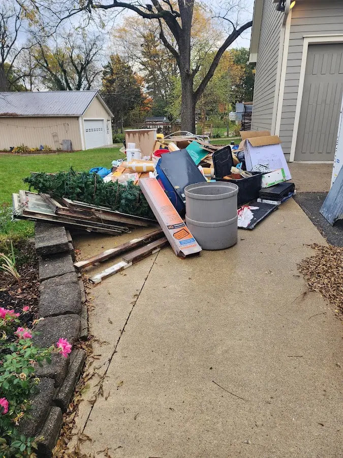 Dumpster being loaded with debris for 12 Yard Dumpster Rental in Des Plaines